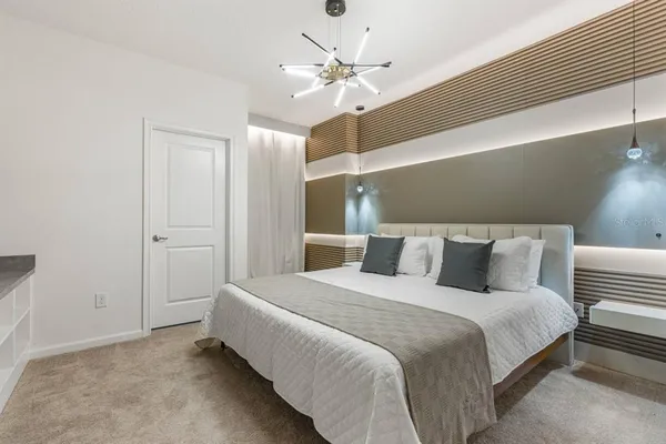 a bedroom with a bed and a ceiling fan