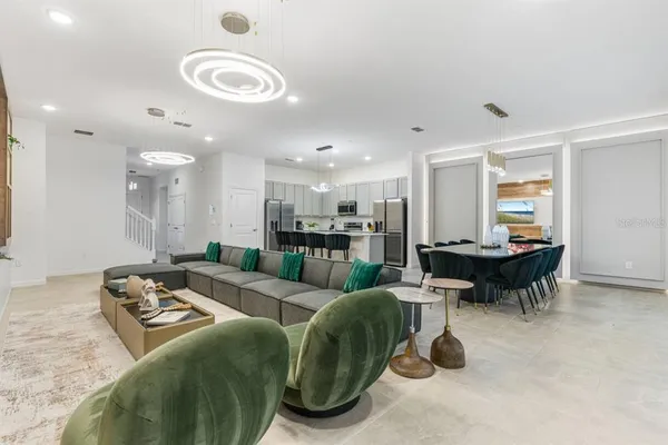 a living room with furniture and a dining table