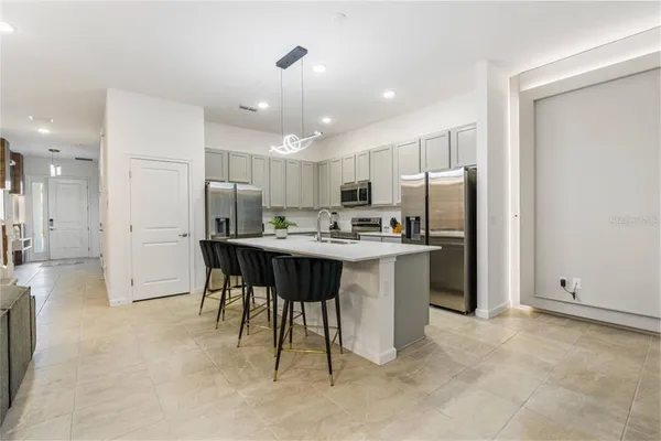 a kitchen with refrigerator cabinets and furniture