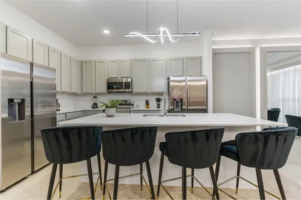 a kitchen with stainless steel appliances a sink and a refrigerator