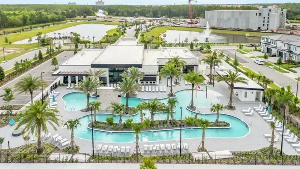 an aerial view of residential houses with outdoor space and river