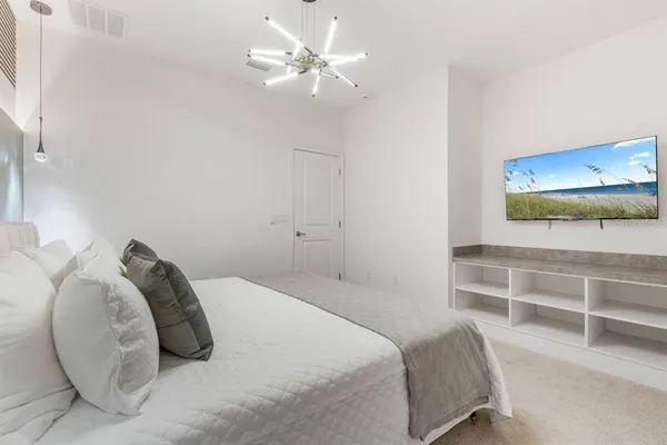 a bedroom with a bed and a ceiling fan