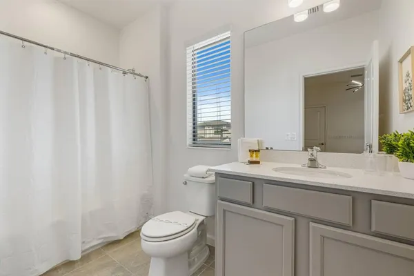 a bathroom with a sink toilet and mirror