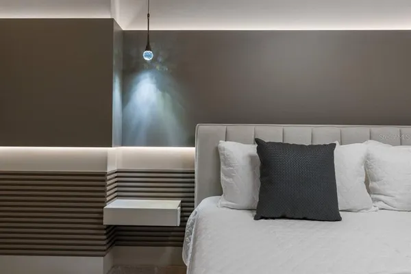 a bedroom with a bed and a night stand