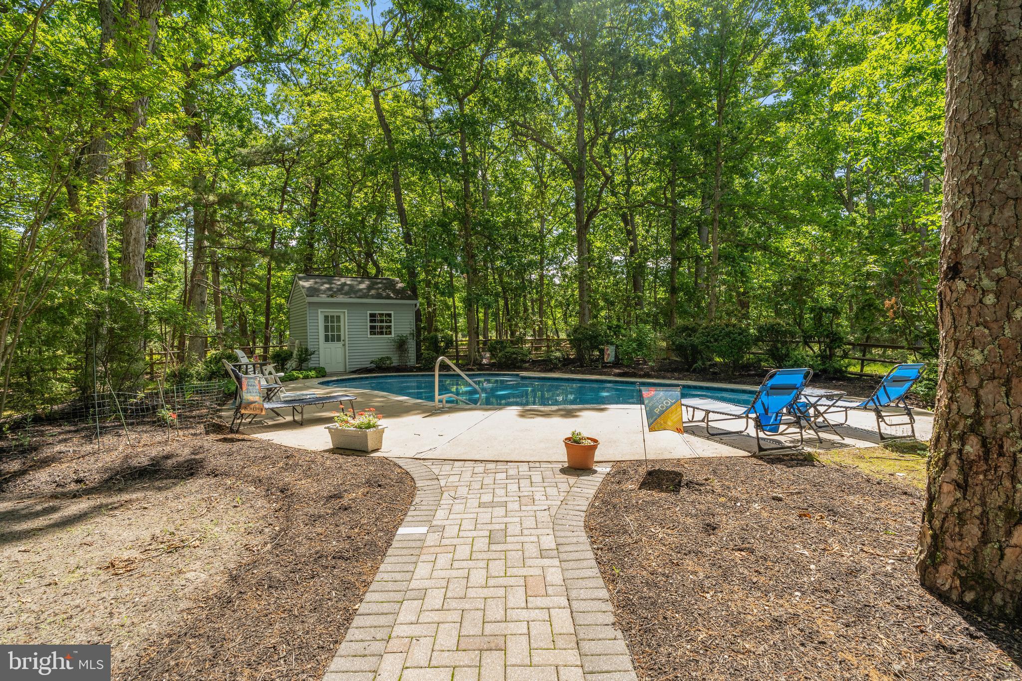 581 McKendimen Road Medford, NJ 08055 - Photo 6 of 34 a view of a swimming pool with a lounge chair
