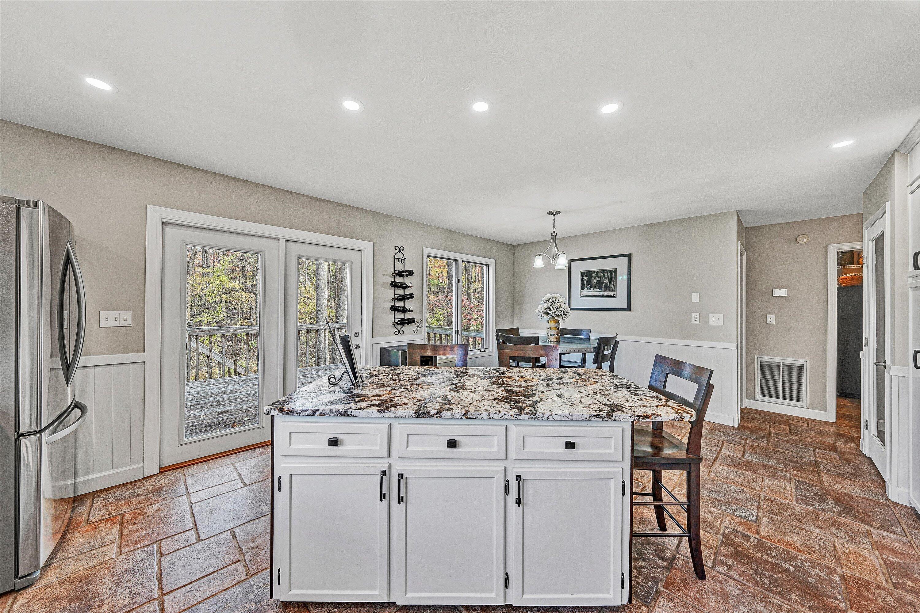 36 York Street Roanoke, VA 24019 - Photo 19 of 90 a kitchen with stainless steel appliances kitchen island granite countertop a table and chairs in it