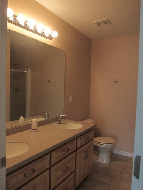 162 Owens Road Fort Mitchell, AL 36856 - Photo 6 of 13 a bathroom with a granite countertop sink a toilet and a mirror