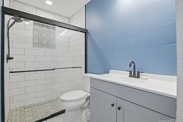 a bathroom with a sink toilet and shower