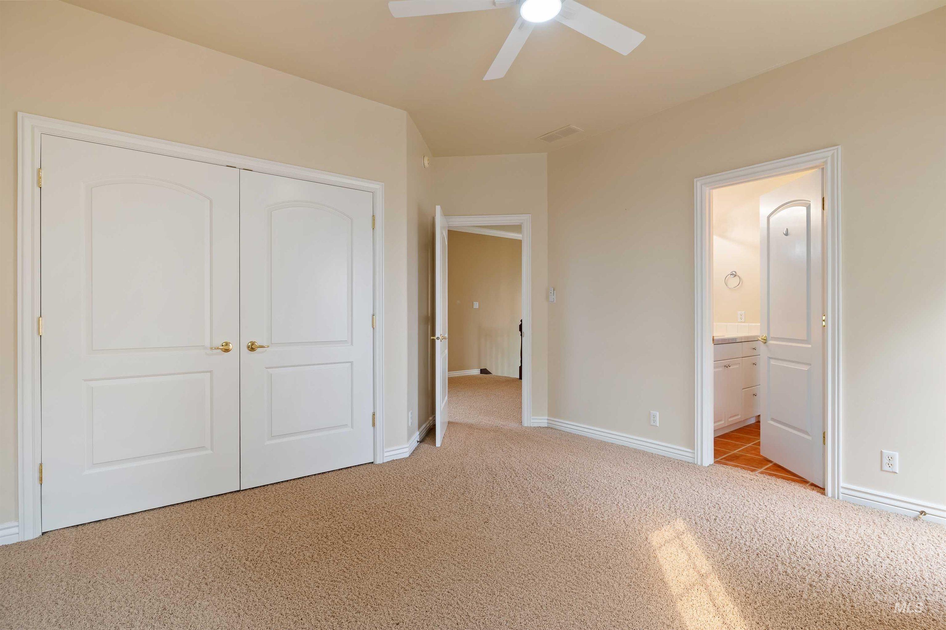 3404 Ridge Line Drive Kimberly, ID 83341 - Photo 27 of 50 Spacious room with plush carpeting, a ceiling fan, and two panel doors