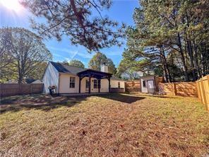 390 Cedarhurst Road Lawrenceville, GA 30045 - Photo 2 of 3 a house that has a tree in front of it