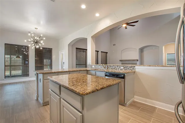 a view of living room kitchen and chandelier