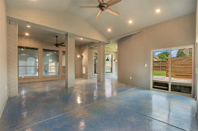 an empty room with windows and entrance