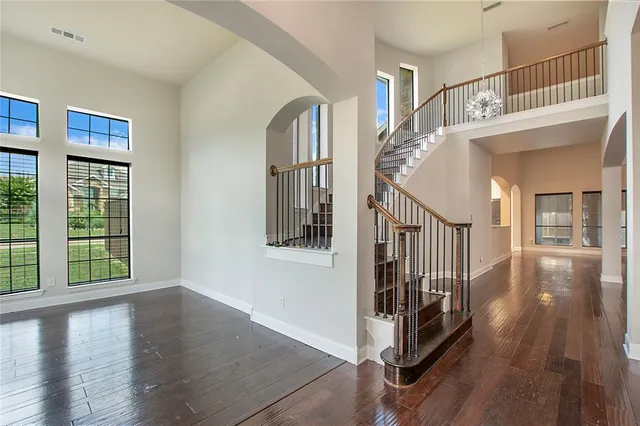 a view of entryway and hall with wooden floor