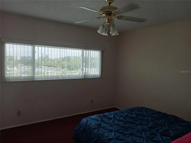 a bed sitting in a room next to a window