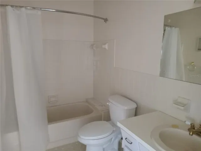 a white toilet sitting next to a bathroom sink