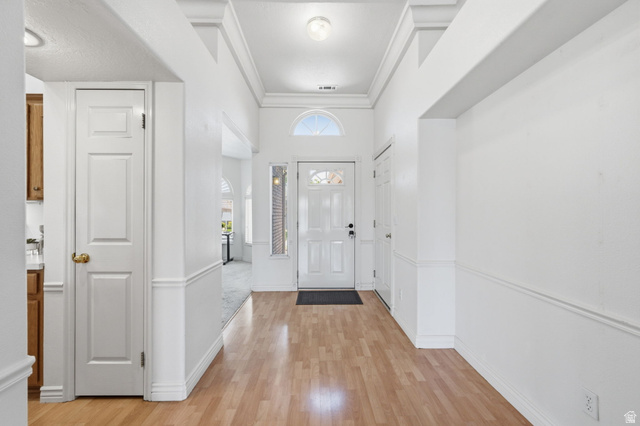 805 South River Road, Unit 70 St. George, UT 84790 - Photo 21 of 38 Entryway with wood-finish flooring, white paneled walls, and crown molding