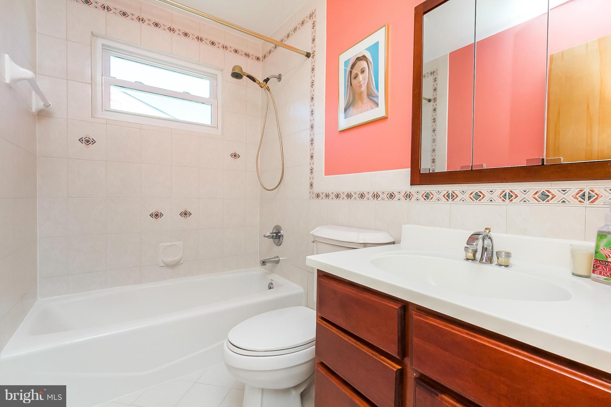 4241 4 Mills Road Baltimore, MD 21236 - Photo 11 of 25 a bathroom with a sink a toilet and a bathtub