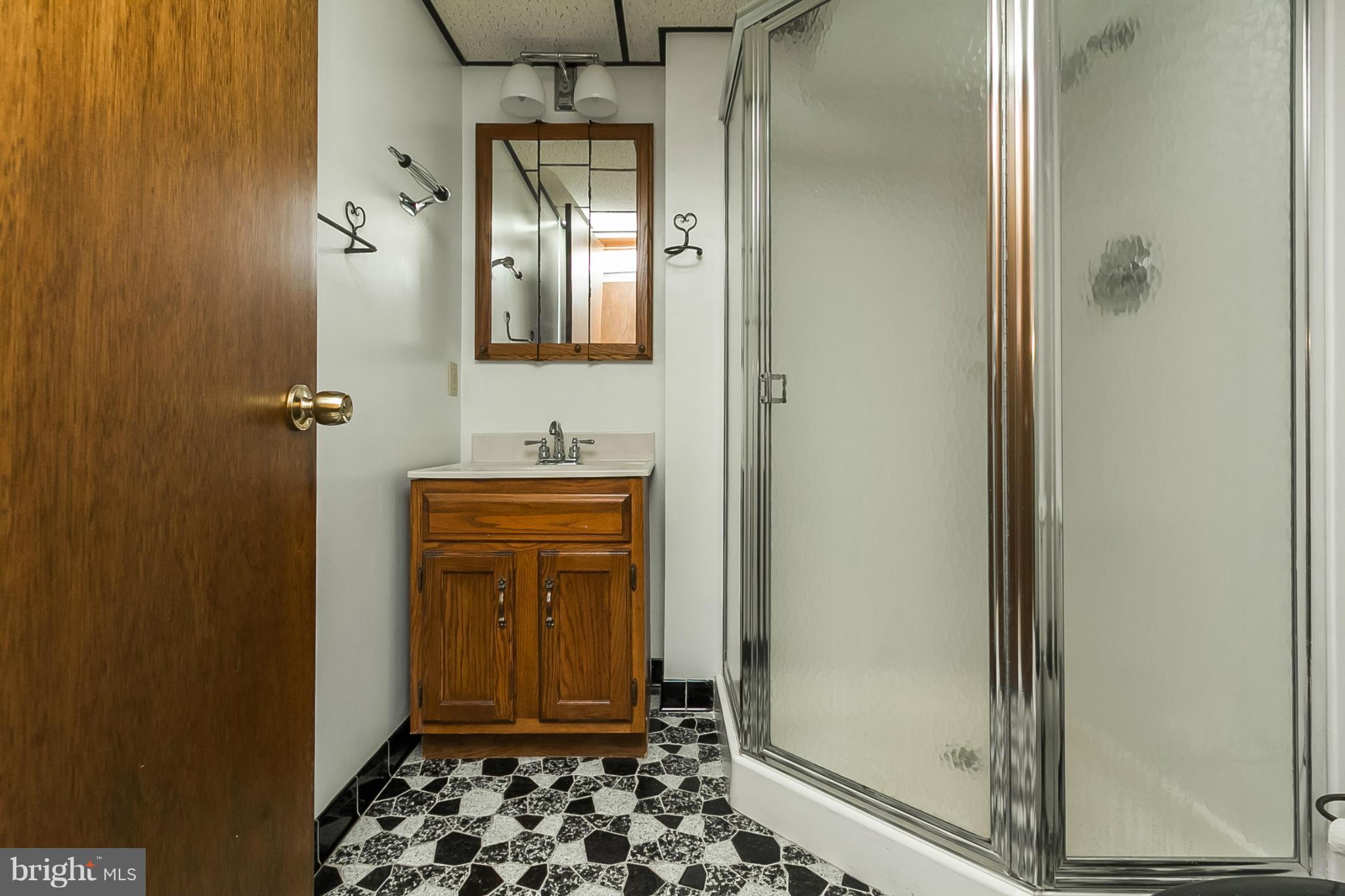 4241 4 Mills Road Baltimore, MD 21236 - Photo 16 of 25 a view of a hallway with wooden floor and a bathroom