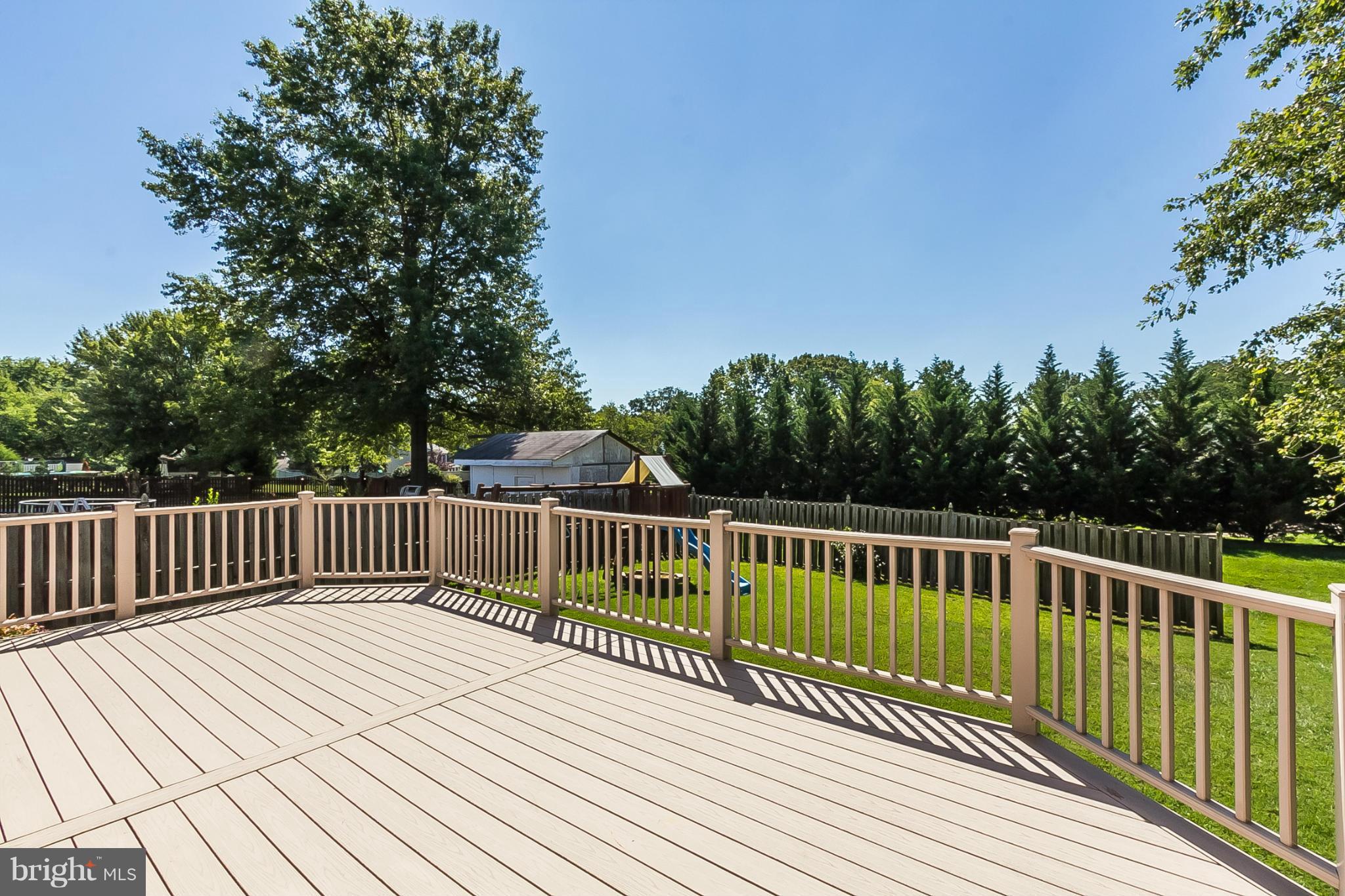 4241 4 Mills Road Baltimore, MD 21236 - Photo 20 of 25 a view of balcony with wooden fence and trees