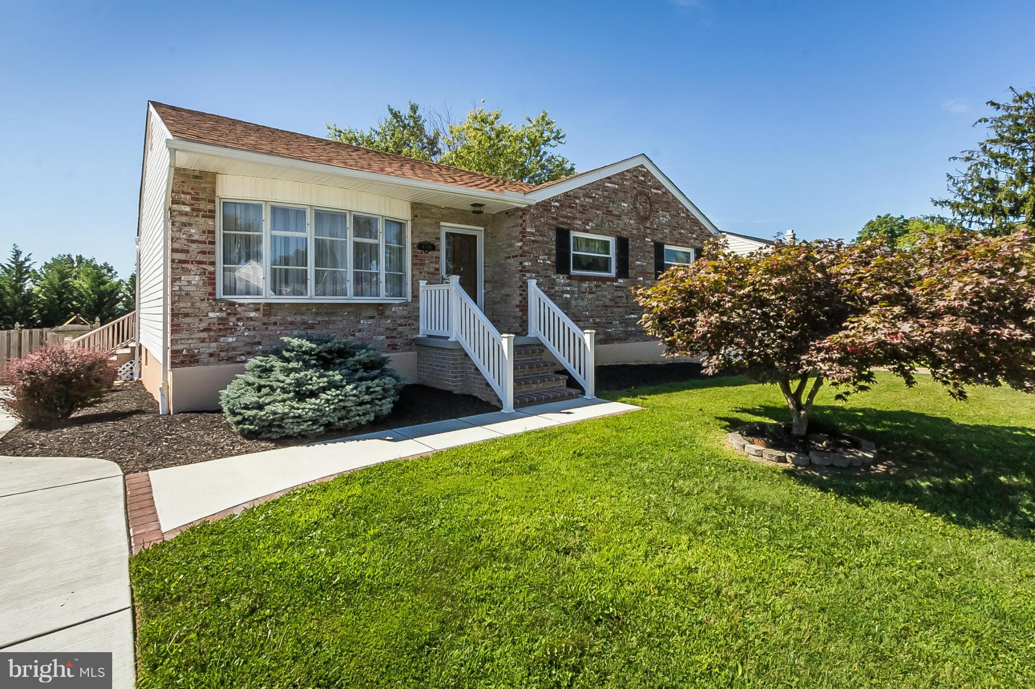 4241 4 Mills Road Baltimore, MD 21236 - Photo 24 of 25 a front view of a house with a yard and potted plants
