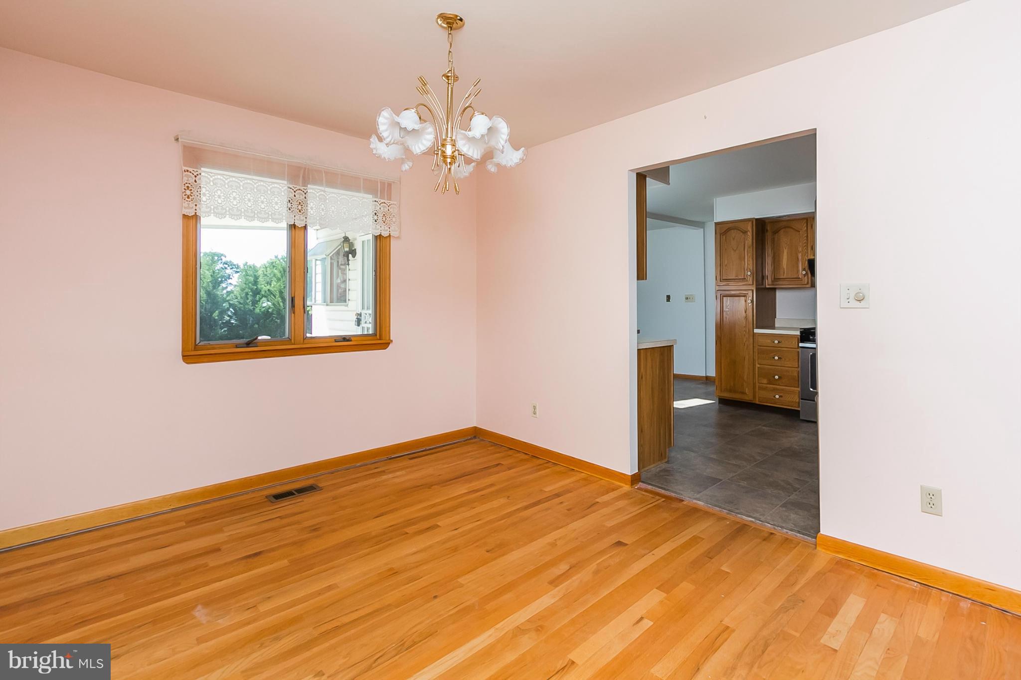 4241 4 Mills Road Baltimore, MD 21236 - Photo 5 of 25 a view of a room with wooden floor and chandelier