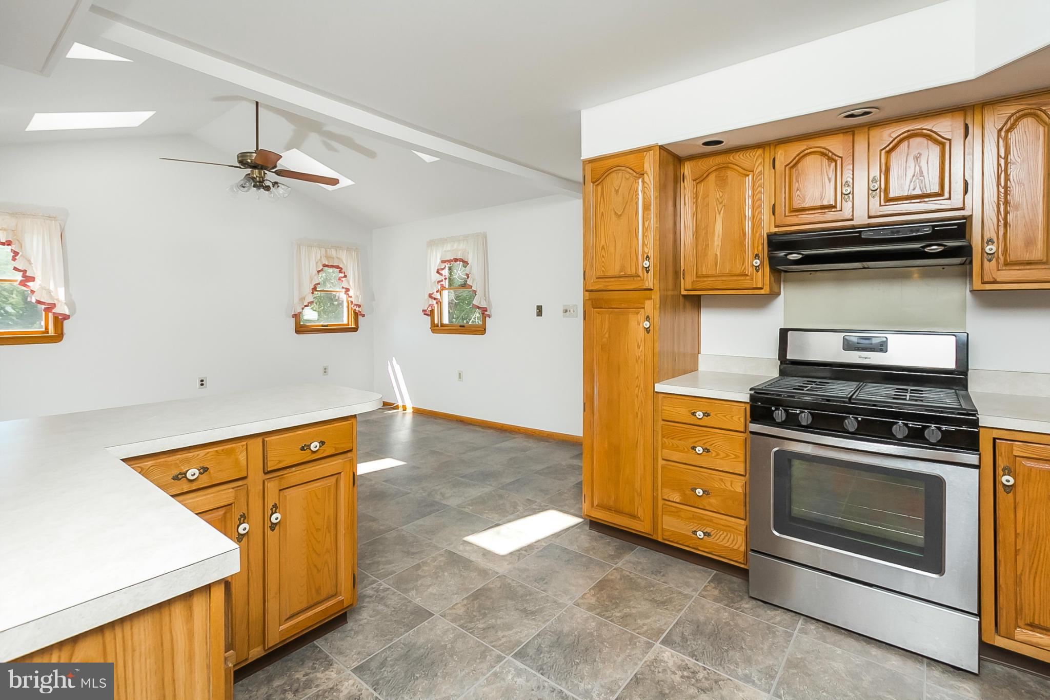 4241 4 Mills Road Baltimore, MD 21236 - Photo 6 of 25 a kitchen with stainless steel appliances granite countertop a stove and a cabinet