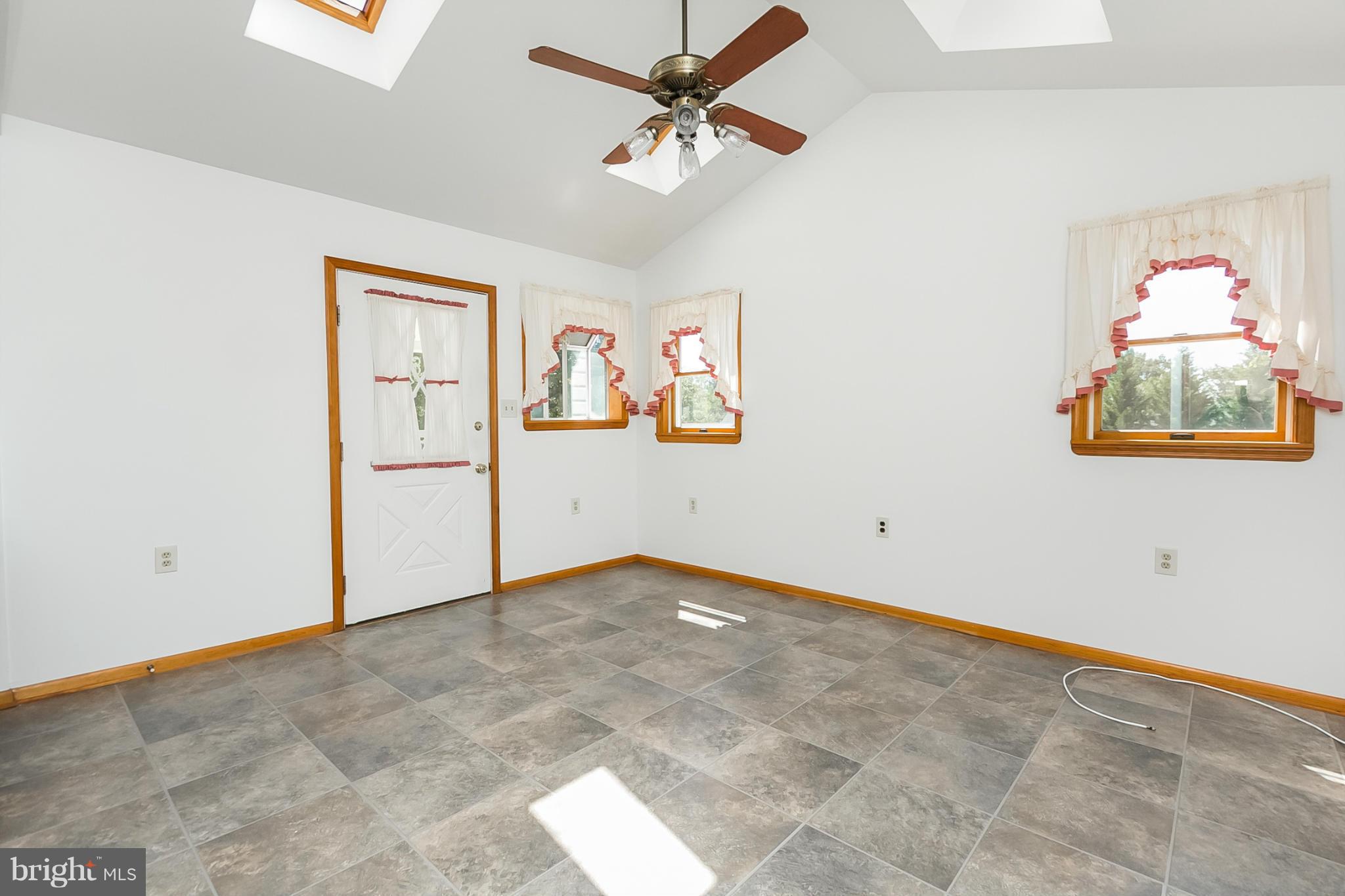4241 4 Mills Road Baltimore, MD 21236 - Photo 10 of 25 an empty room with windows and fan