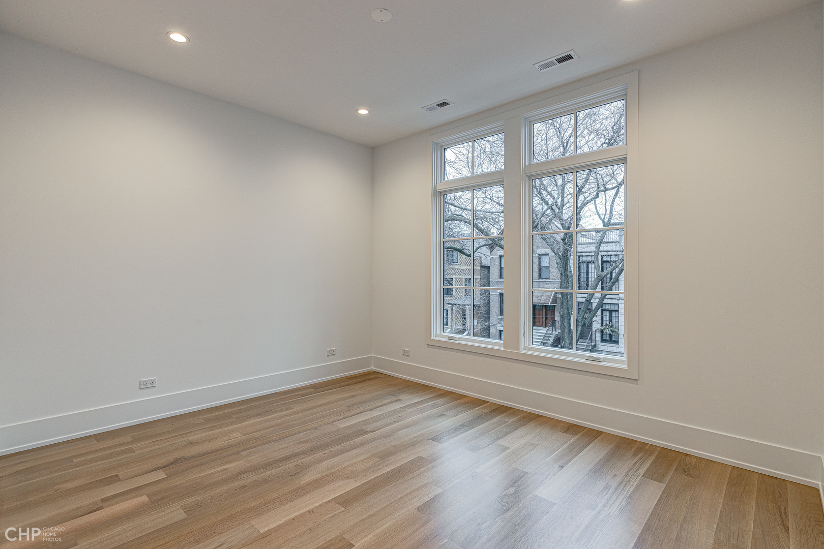 Undisclosed Address Chicago, IL 60622 - Photo 8 of 17 an empty room with wooden floor and windows