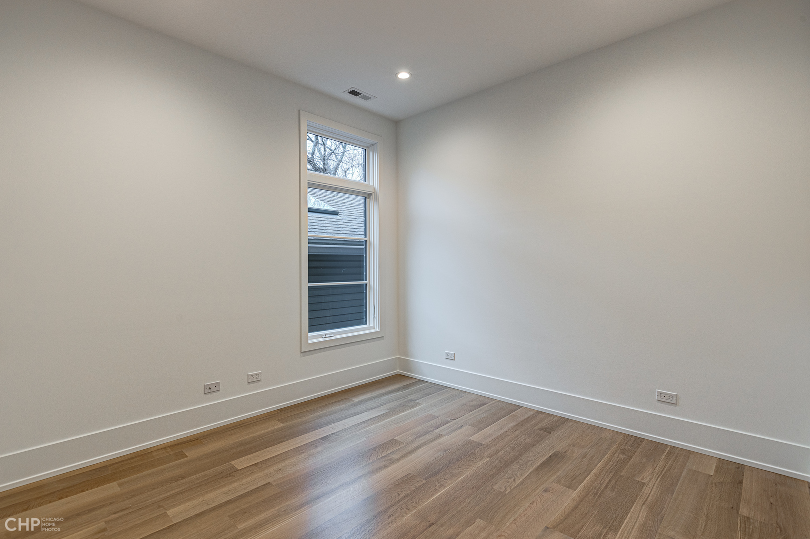 Undisclosed Address Chicago, IL 60622 - Photo 9 of 17 an empty room with wooden floor and windows