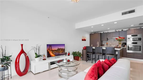 a living room with furniture kitchen and a table