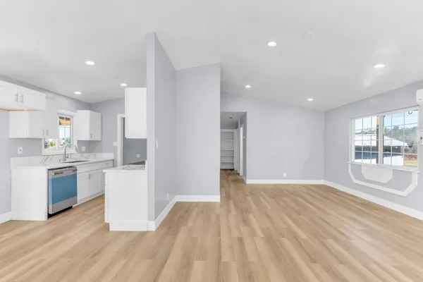 a view of a kitchen with kitchen island wooden floors wooden floor and center island