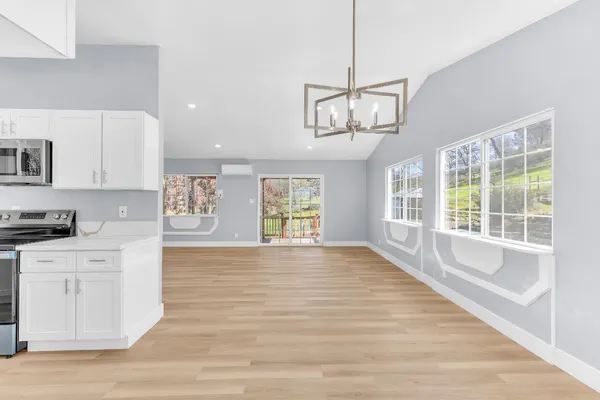 a view of a kitchen with a sink dishwasher and wooden floor