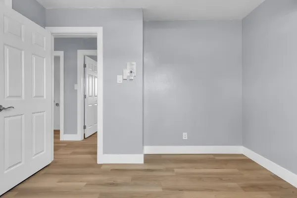a view of a room with wooden floor