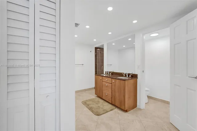 a view of kitchen with stainless steel appliances granite countertop cabinets