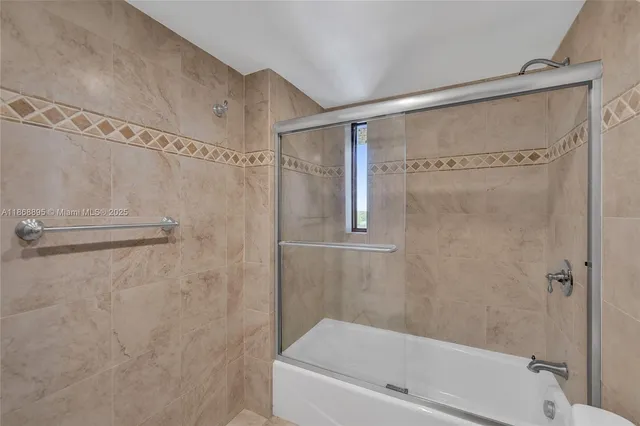 a bathroom with a shower and a bath tub