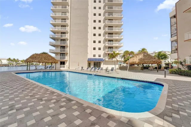 a backyard of a house with lake view and a floor to ceiling window