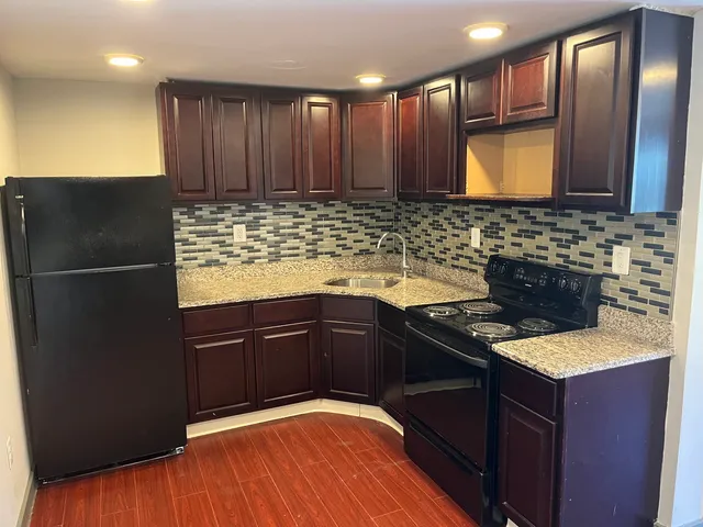 a kitchen with granite countertop stainless steel appliances and wooden cabinets