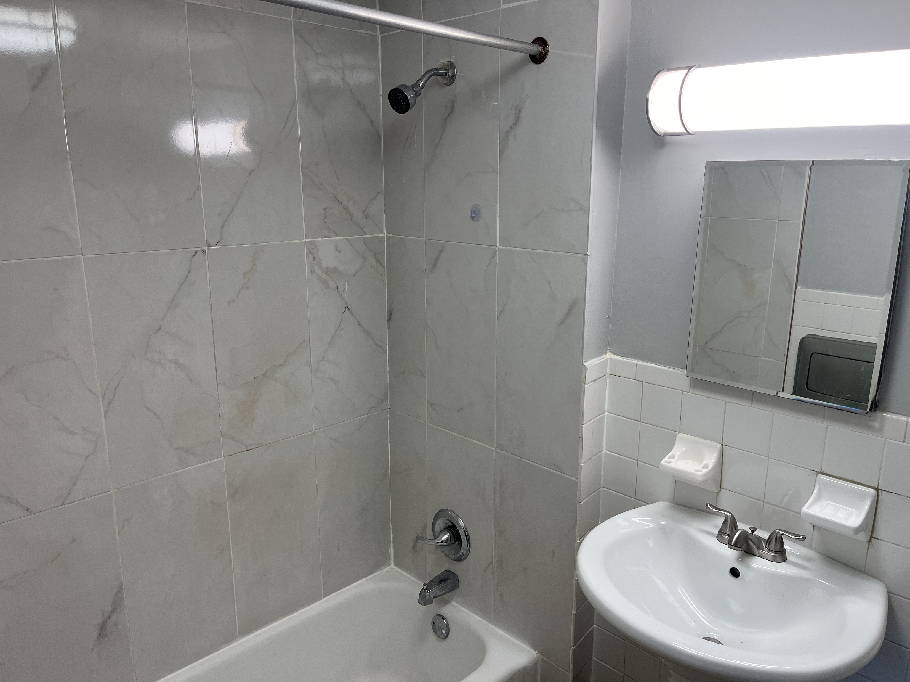 32 Cook Avenue, Unit 203 Meriden, CT 06451 - Photo 7 of 11 a bathroom with a sink a mirror and shower