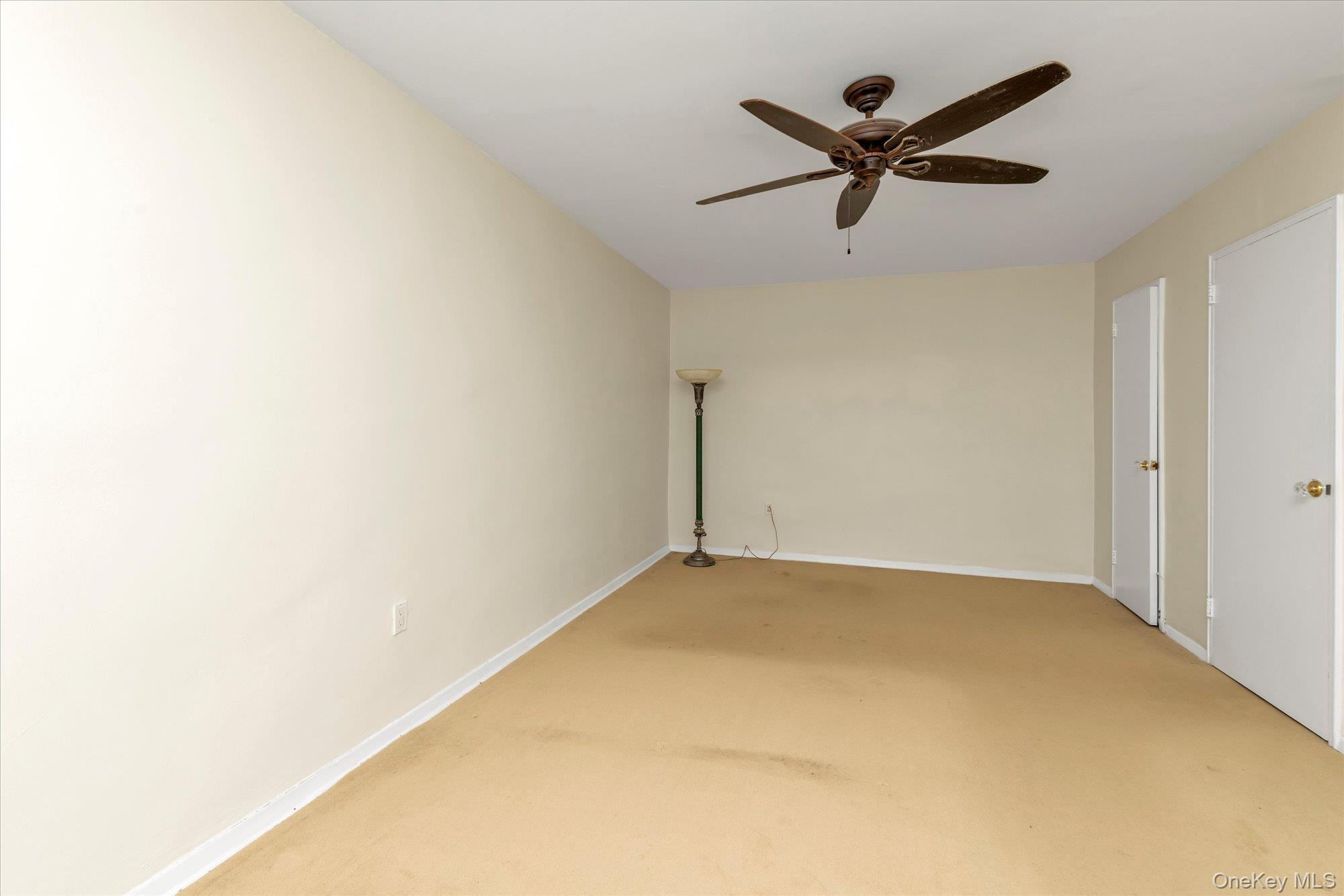 30 Pearsall Avenue, Unit 2F Glen Cove, NY 11542 - Photo 15 of 25 Bedroom with light colored carpet and a ceiling fan