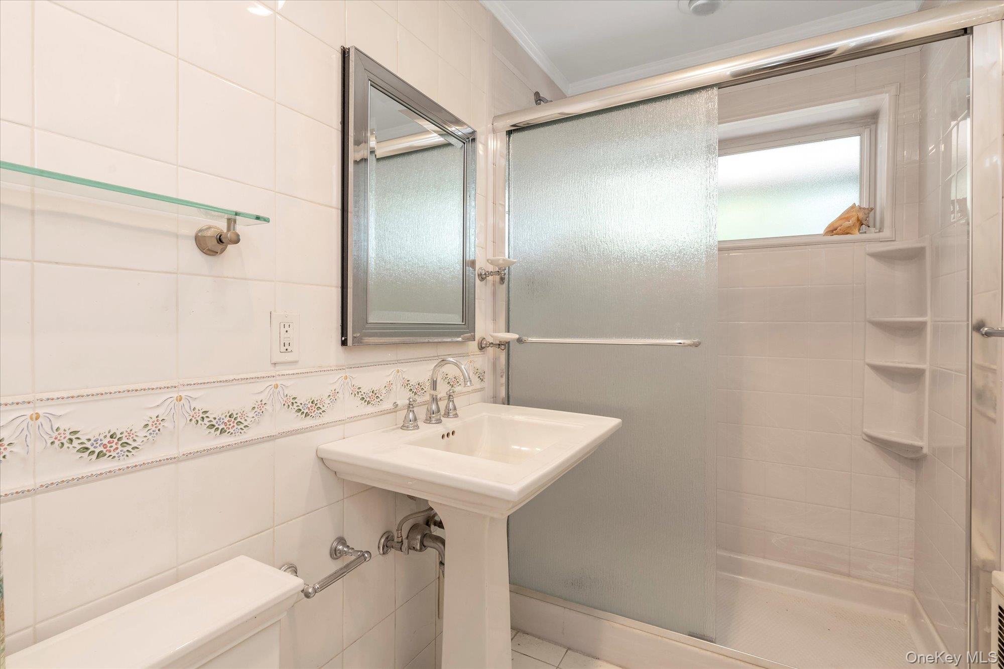 30 Pearsall Avenue, Unit 2F Glen Cove, NY 11542 - Photo 16 of 25 Full bath featuring tile walls, a shower stall, and ornamental molding