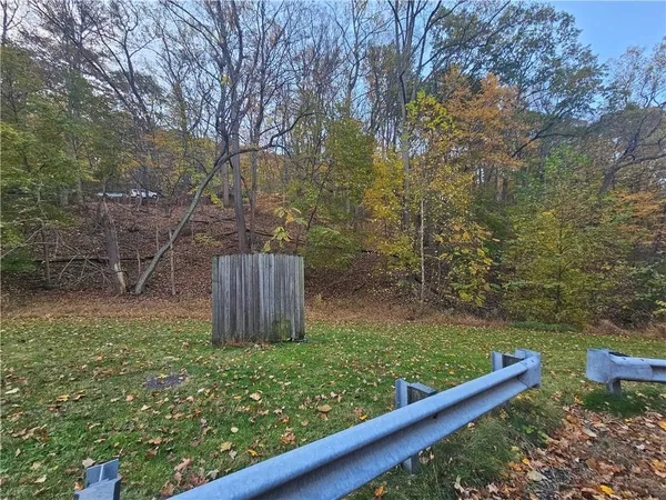 a view of a garden with wooden fence