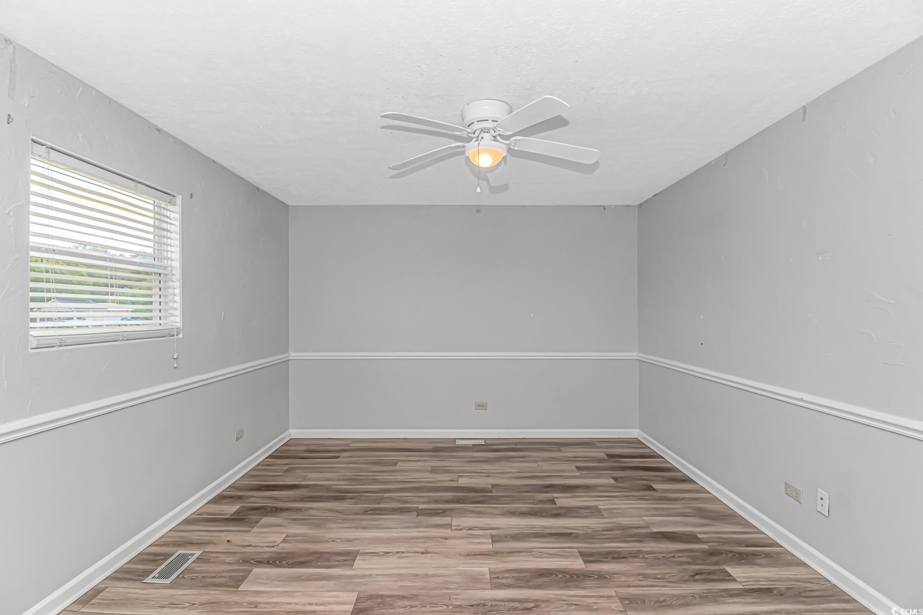 2829 Highway 129 Galivants Ferry, SC 29544 - Photo 15 of 40 Empty room with ceiling fan and wood finished floors