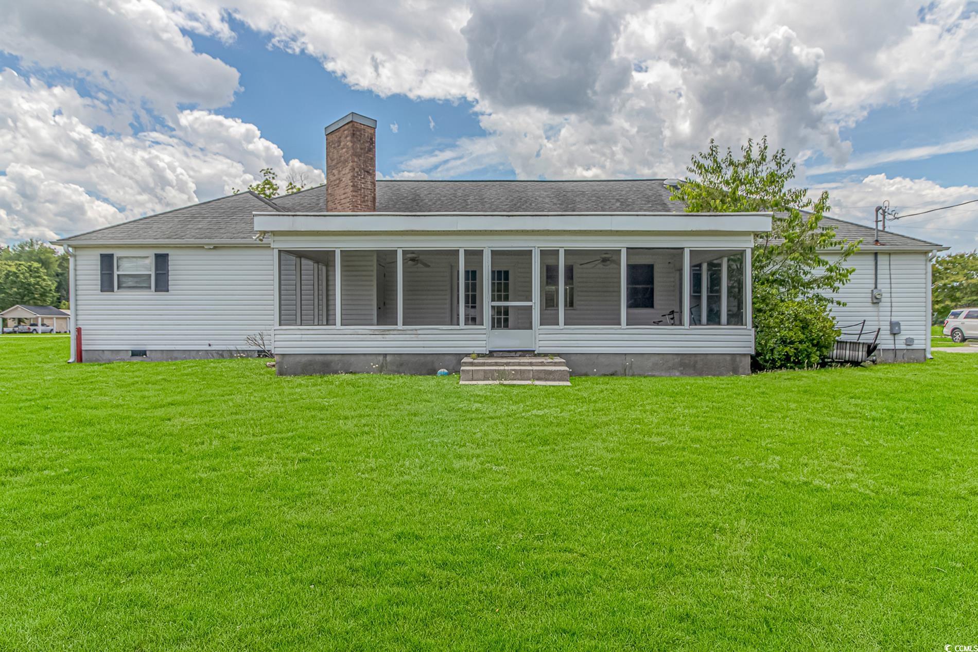 2829 Highway 129 Galivants Ferry, SC 29544 - Photo 22 of 40 Back of house featuring a sunroom, a yard, a ceiling fan, a chimney, and crawl space