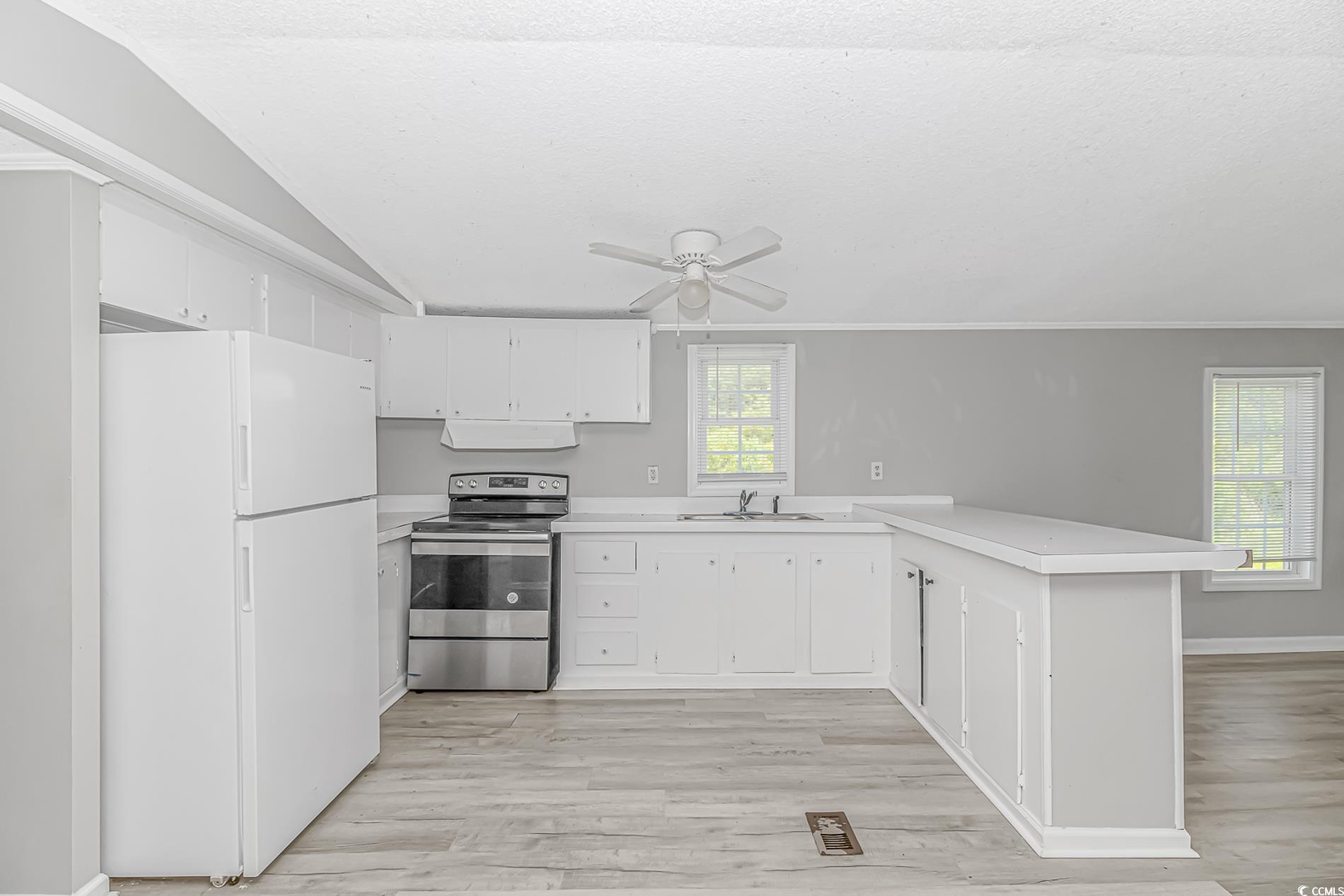 2829 Highway 129 Galivants Ferry, SC 29544 - Photo 27 of 40 Kitchen featuring freestanding refrigerator, electric range, ventilation hood, a peninsula, and light countertops