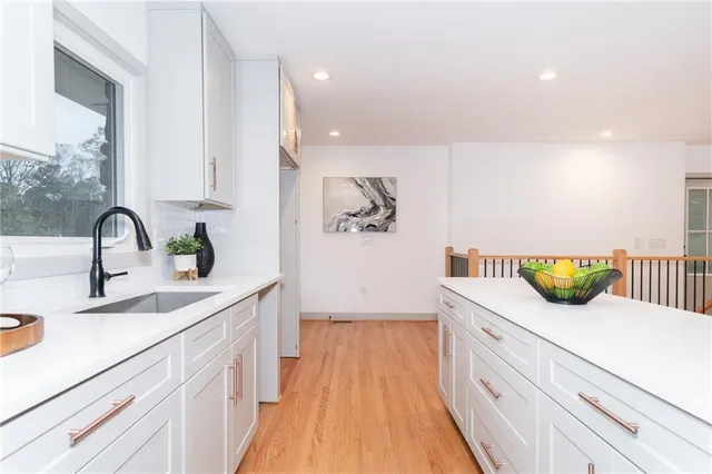 a kitchen with a sink and a refrigerator