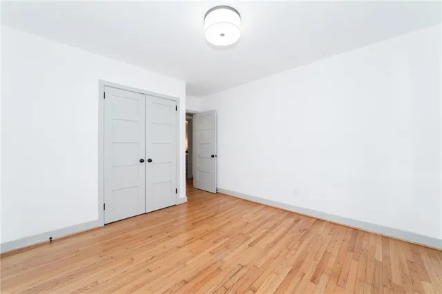 a view of a room with wooden floor and white walls