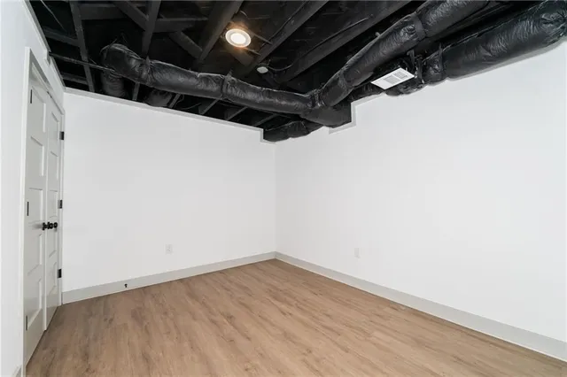 a view of a room with wooden floor
