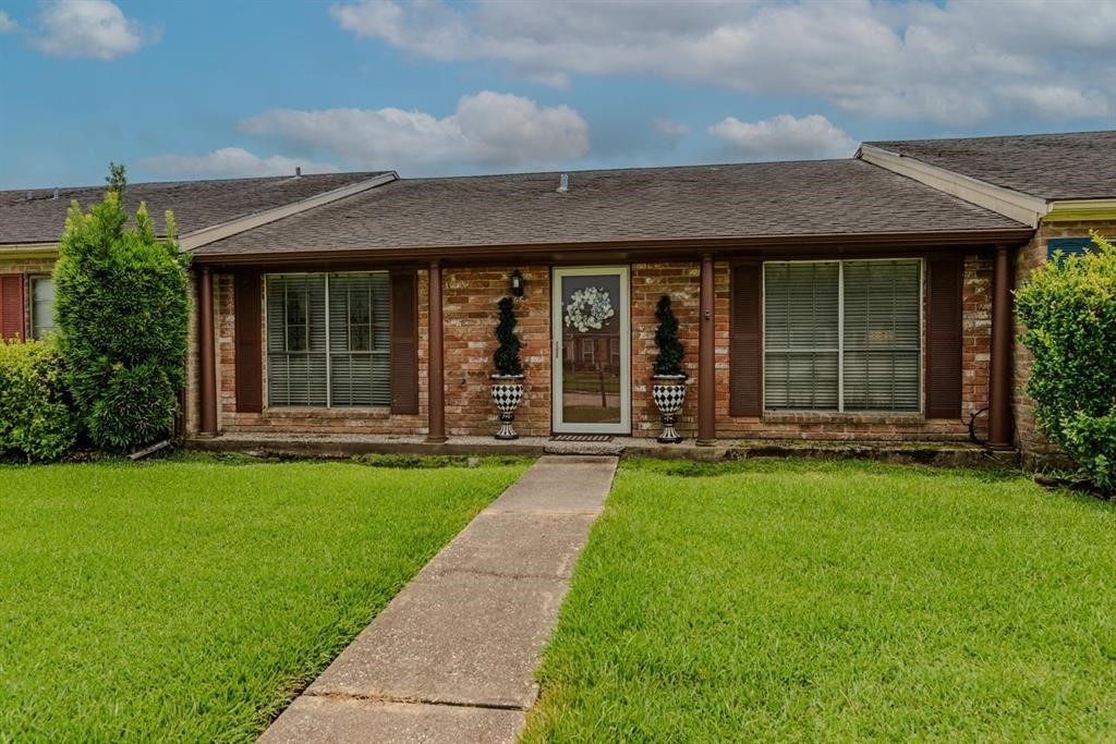 5975 Meadow Way Beaumont, TX 77707 - Photo 2 of 18 front view of a brick house with a yard