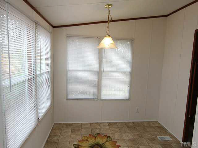 4501 Durham Road Raleigh, NC 27614 - Photo 6 of 12 a view of a room with a window and wooden floor