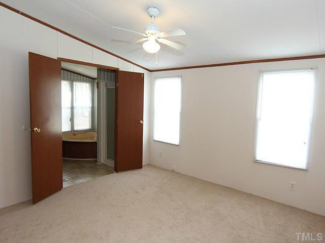 4501 Durham Road Raleigh, NC 27614 - Photo 7 of 12 an empty room with windows and fan